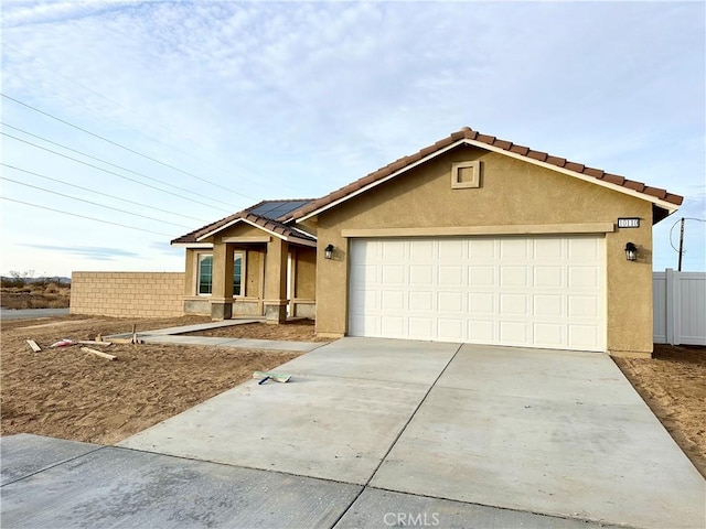 view of front of house with a garage and solar panels