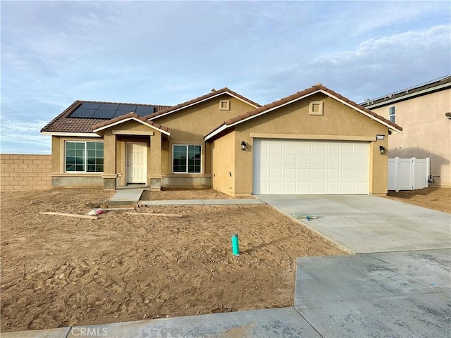 view of front of home with a garage and solar panels