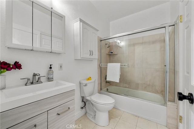 full bathroom with toilet, bath / shower combo with glass door, tile patterned flooring, and vanity