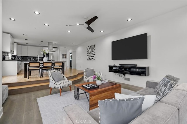 living room featuring ceiling fan and wood-type flooring