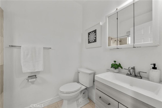 bathroom with vanity, toilet, and tile patterned floors