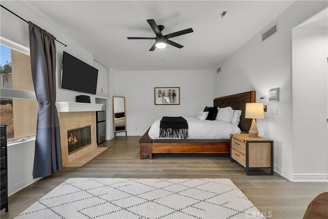 8350 Hillcroft Dr, West Hills, CA 91304 - bedroom with wood finished floors, a fireplace, and baseboards
