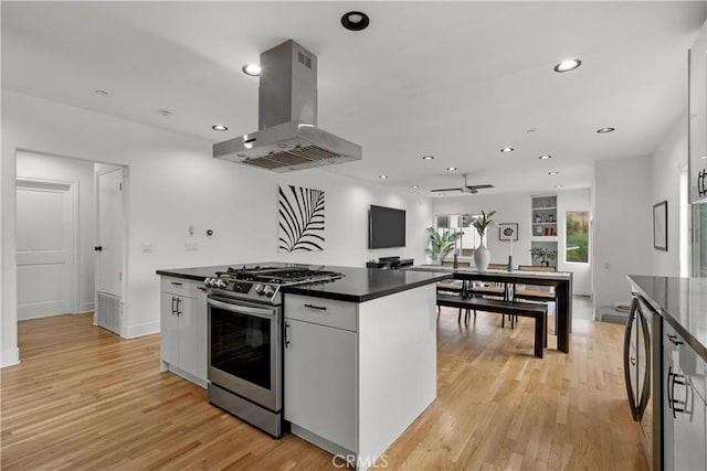 8350 Hillcroft Dr, West Hills, CA 91304 - kitchen with stainless steel range with gas cooktop, island exhaust hood, dark countertops, light wood-style floors, and recessed lighting
