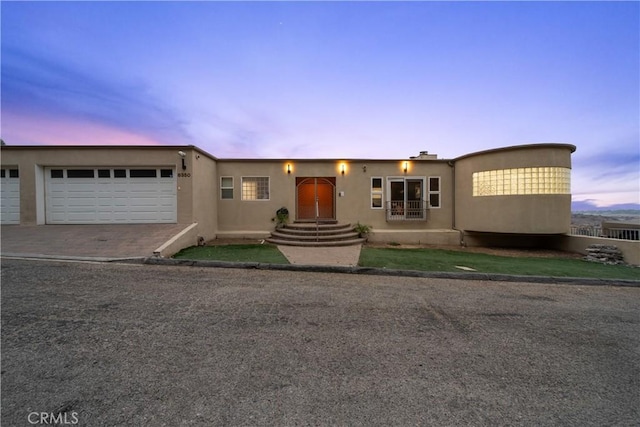 8350 Hillcroft Dr, West Hills, CA 91304 - view of front of home with an attached garage, stucco siding, and driveway