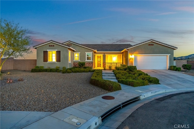 single story home featuring a porch and a garage