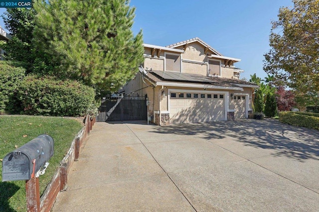 view of front of property with solar panels and a garage