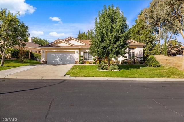 view of front of property with a garage and a front yard