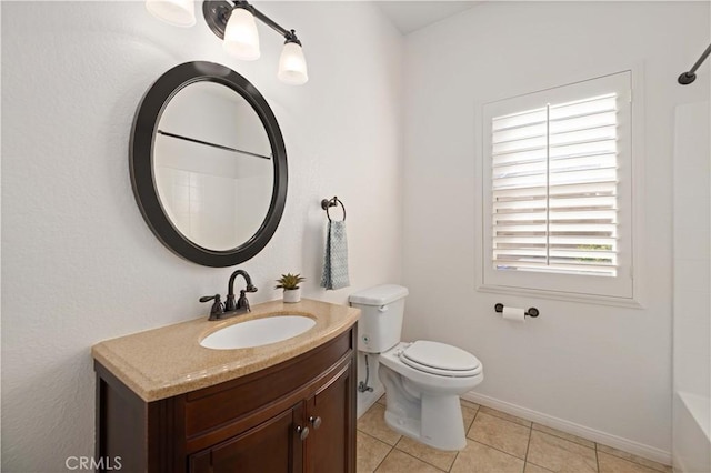 bathroom featuring tile patterned flooring, vanity, and toilet