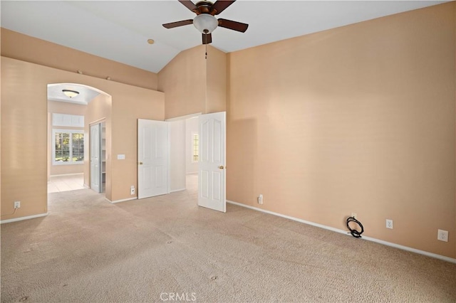 carpeted empty room featuring ceiling fan and lofted ceiling