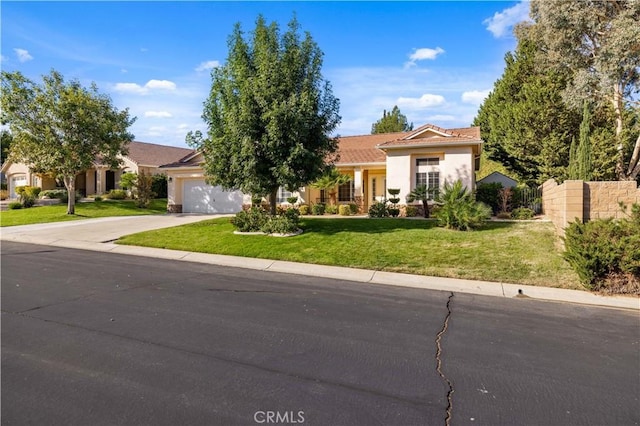 view of front of house with a front yard and a garage