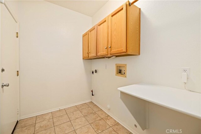 laundry area with cabinets, hookup for a washing machine, light tile patterned floors, and hookup for a gas dryer