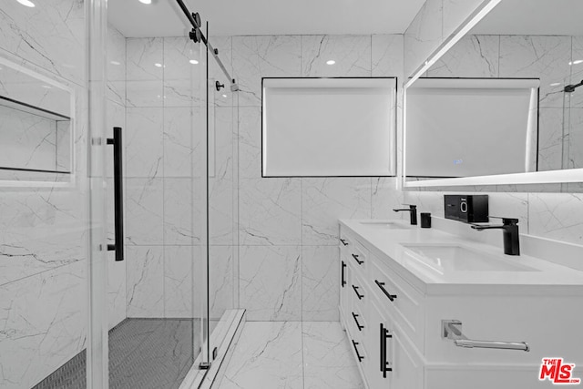 bathroom featuring a shower with door, tile walls, and vanity