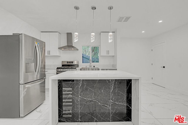 kitchen with white cabinetry, stainless steel appliances, and wall chimney exhaust hood