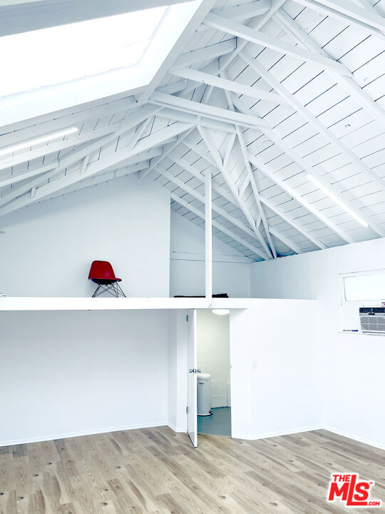 room details featuring wood-type flooring and beamed ceiling