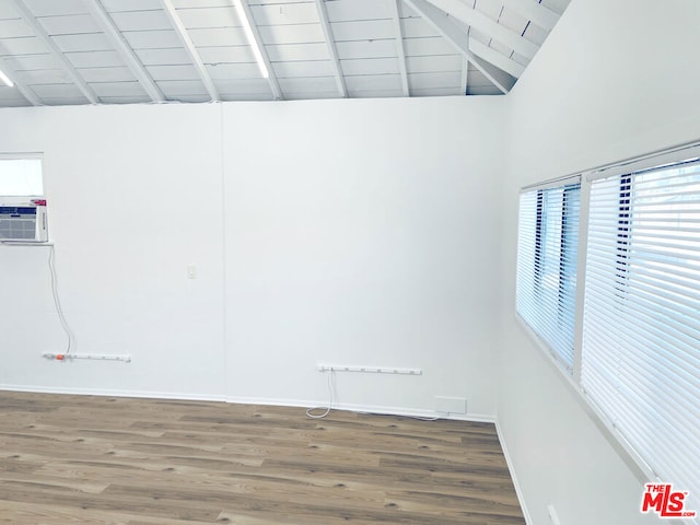 spare room with wood ceiling, hardwood / wood-style floors, beam ceiling, and high vaulted ceiling