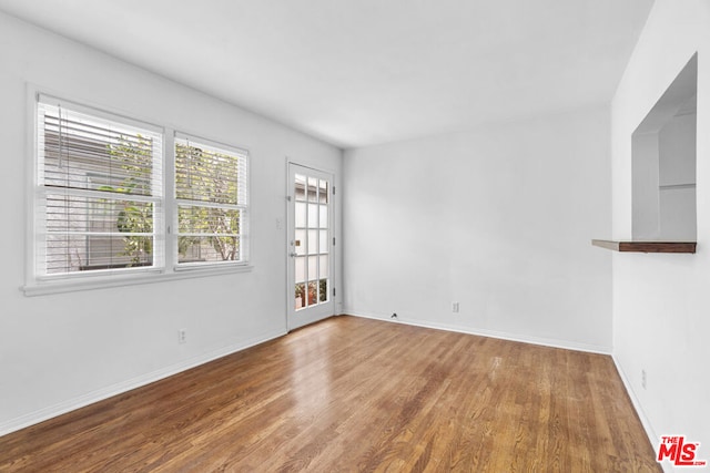 empty room with hardwood / wood-style flooring