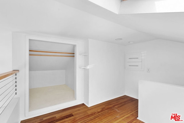 spacious closet with vaulted ceiling and hardwood / wood-style floors