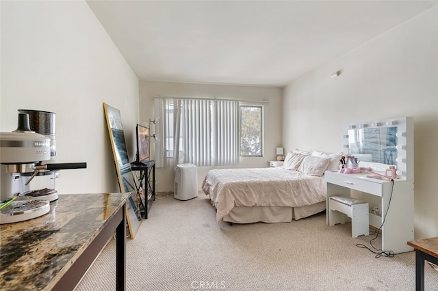 bedroom featuring light carpet