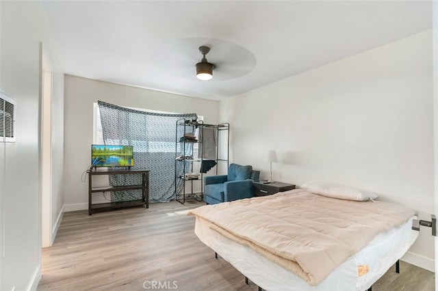 bedroom featuring light hardwood / wood-style flooring and ceiling fan