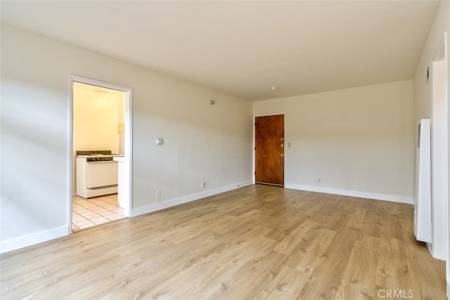 spare room with light hardwood / wood-style floors