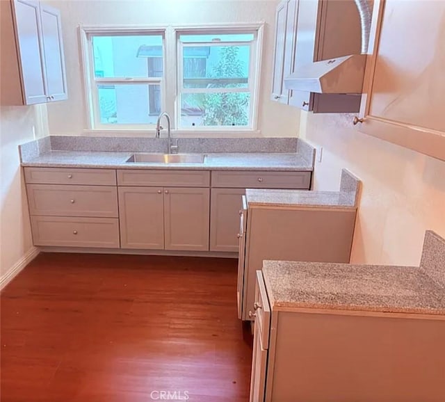 2219 Pine Ave, Long Beach, CA 90806 - kitchen featuring dark wood-style floors, a sink, light countertops, and under cabinet range hood
