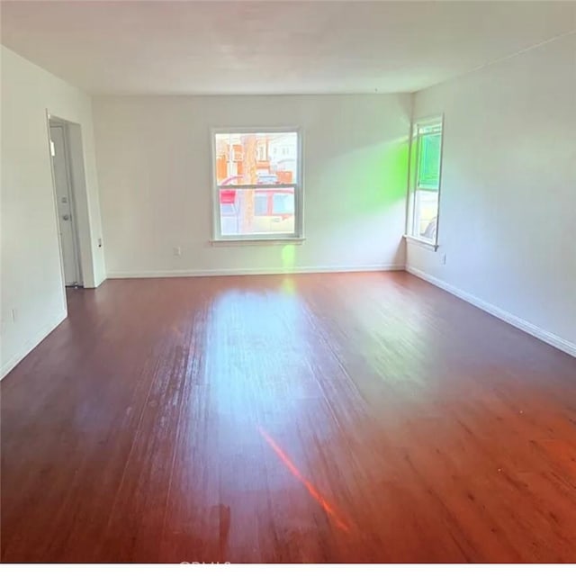 2219 Pine Ave, Long Beach, CA 90806 - spare room with plenty of natural light, wood finished floors, and baseboards