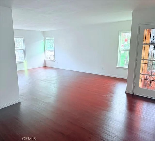 2219 Pine Ave, Long Beach, CA 90806 - empty room featuring dark wood-style floors and baseboards