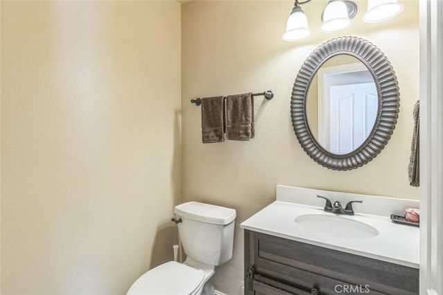 bathroom featuring toilet and vanity