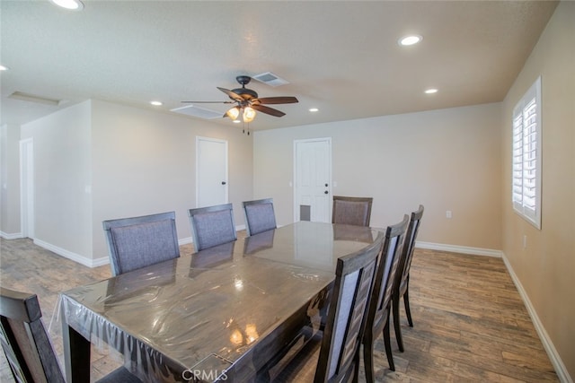 dining area featuring dark wood-type flooring and ceiling fan