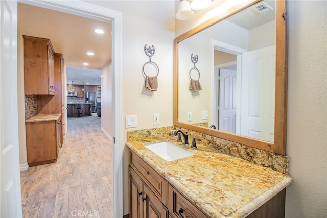 bathroom with vanity and hardwood / wood-style flooring