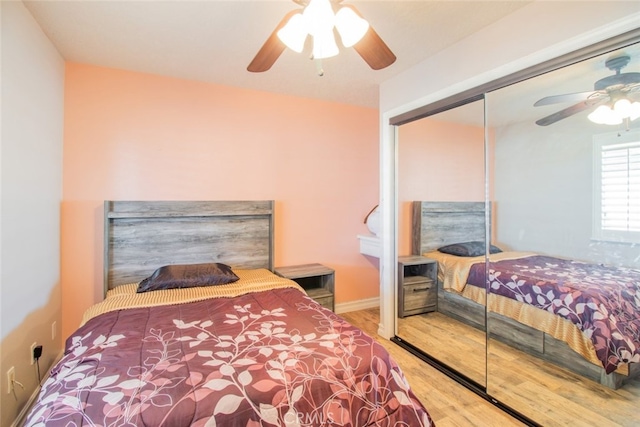 bedroom featuring hardwood / wood-style flooring, a closet, and ceiling fan