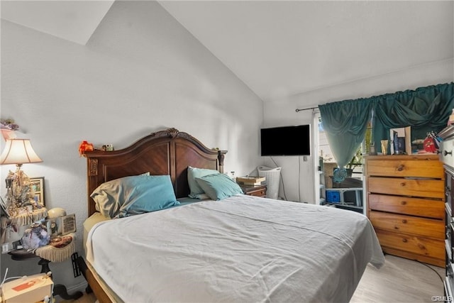 bedroom featuring light hardwood / wood-style flooring and vaulted ceiling