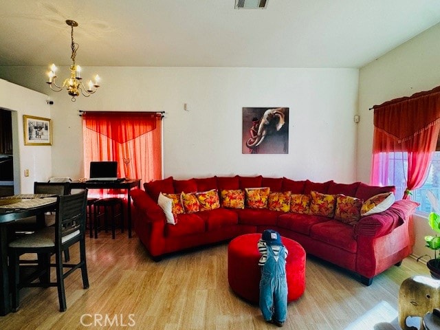 living room with an inviting chandelier and hardwood / wood-style floors