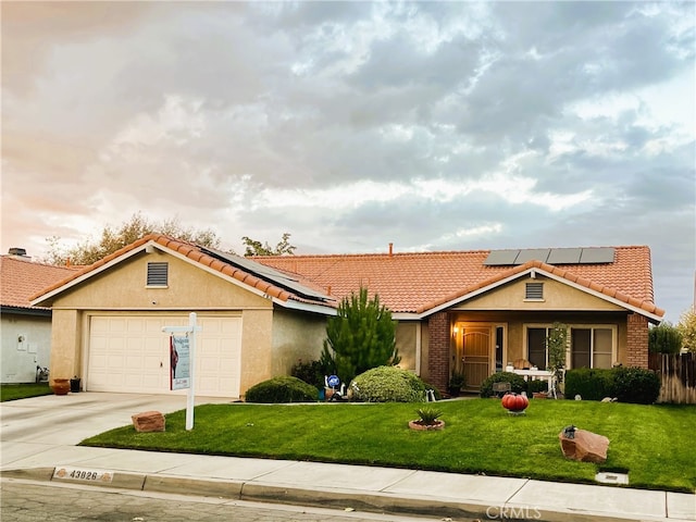 ranch-style home featuring a front yard and a garage