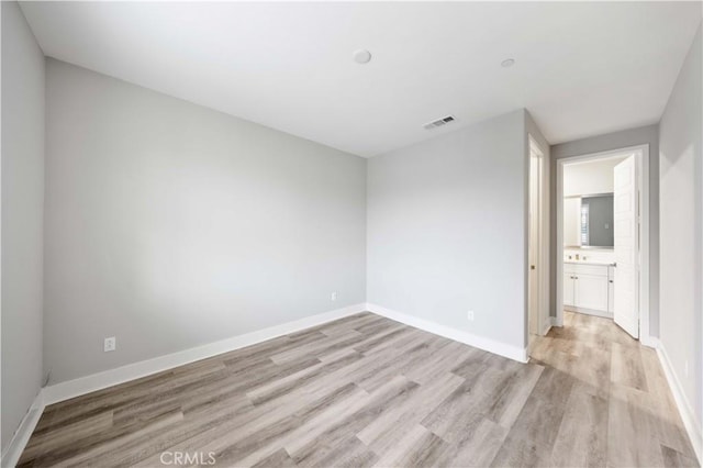 spare room featuring light wood-type flooring