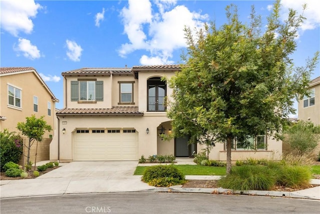 mediterranean / spanish house featuring a garage