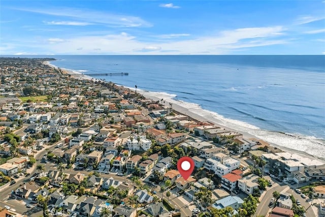 drone / aerial view featuring a water view and a beach view