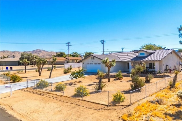 view of front of home with a mountain view and a garage