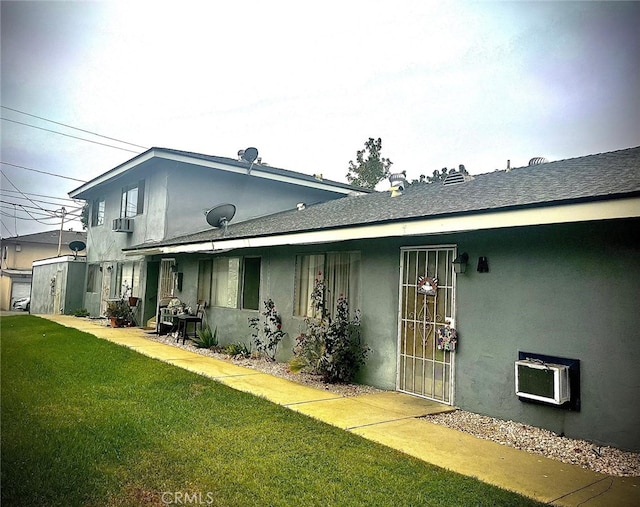 back of property with a yard, a patio area, and cooling unit