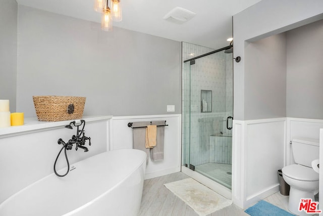 bathroom featuring separate shower and tub and toilet