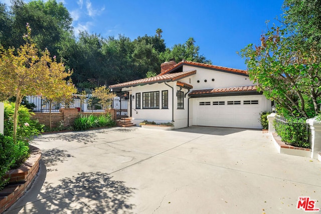 mediterranean / spanish-style home with a garage