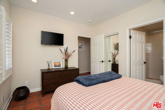 tiled bedroom featuring ensuite bathroom