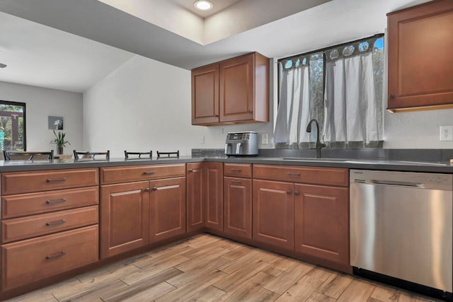 kitchen featuring light hardwood / wood-style floors, stainless steel dishwasher, and sink