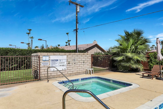 view of pool with a hot tub