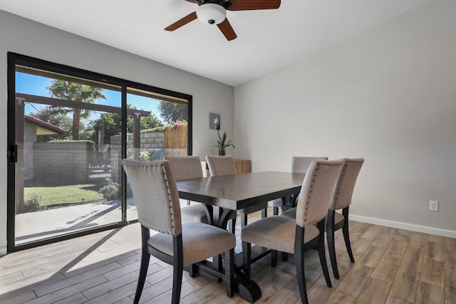 dining area with light wood-type flooring and ceiling fan