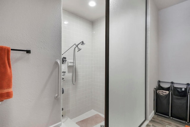 bathroom with walk in shower and wood-type flooring