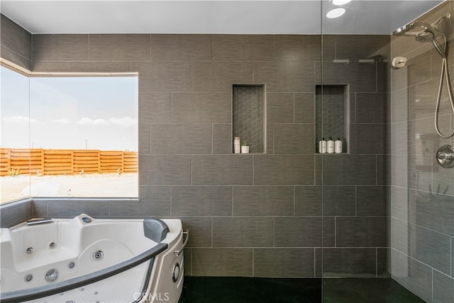 bathroom featuring separate shower and tub and tile walls