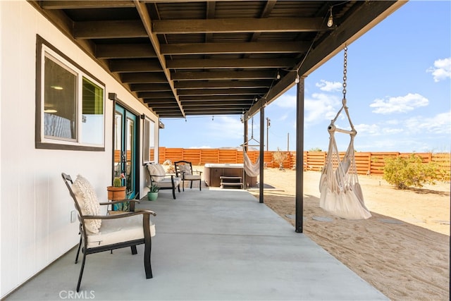 view of patio / terrace with a hot tub