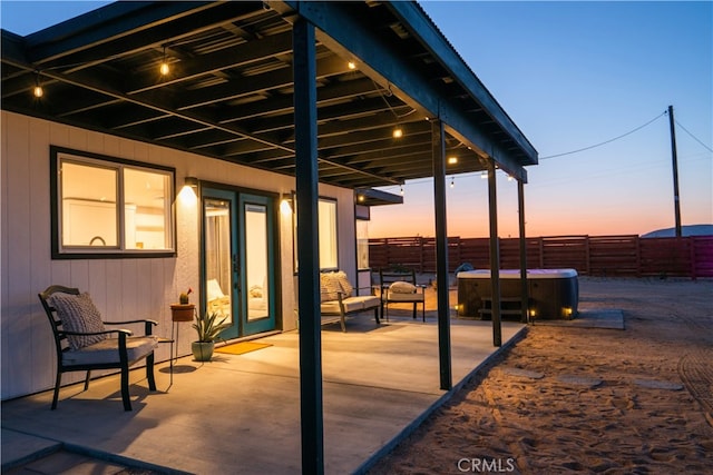 patio terrace at dusk with french doors and a hot tub