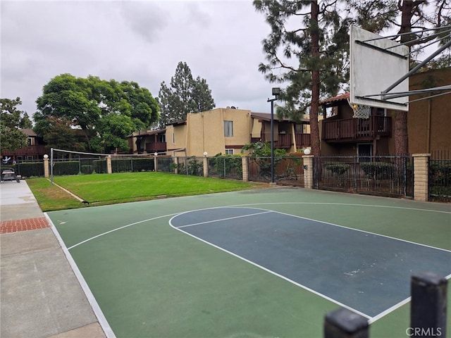 view of basketball court with a yard